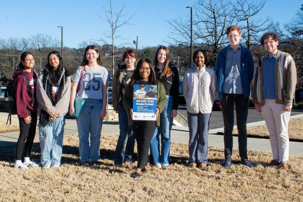 College students part of the High-Dosage Tutoring Program smile for a photo.